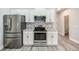 Bright kitchen showcasing stainless steel appliances and white cabinetry at 9020 Amberly Way, Cumming, GA 30028