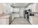 Modern kitchen featuring white cabinets, granite counters, and stainless steel appliances at 9020 Amberly Way, Cumming, GA 30028