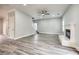 Large living room with hardwood floors, a fireplace, and a ceiling fan at 9020 Amberly Way, Cumming, GA 30028