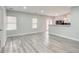 Spacious living room with light gray walls and wood-look flooring at 9020 Amberly Way, Cumming, GA 30028