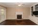 Living room with hardwood floors, fireplace, and built-in shelving at 9921 Between The Grns, Villa Rica, GA 30180