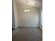 Simple dining area with neutral carpeting and a chandelier at 2770 Stony Place Ct, Grayson, GA 30017