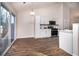 Kitchen with white cabinets, wood floors, and deck access at 2770 Stony Place Ct, Grayson, GA 30017