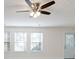 Bright living room with neutral walls, three windows, and ceiling fan at 2770 Stony Place Ct, Grayson, GA 30017