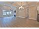 Open dining room and living room area with hardwood floors and chandelier at 4821 Josie Way, Acworth, GA 30101