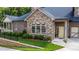 Stone and brick townhome with landscaped yard and two-car garage at 4821 Josie Way, Acworth, GA 30101