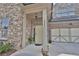 Inviting front entrance with light yellow door and stone accents at 4821 Josie Way, Acworth, GA 30101