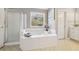 Relaxing bathroom with garden tub and window at 575 Maple Crest Dr, Lawrenceville, GA 30044