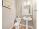 Clean and updated powder room with pedestal sink at 575 Maple Crest Dr, Lawrenceville, GA 30044