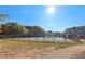 Tennis court surrounded by a black fence at 575 Maple Crest Dr, Lawrenceville, GA 30044