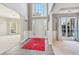 Two-story foyer with columns and a red area rug at 575 Maple Crest Dr, Lawrenceville, GA 30044