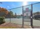 Tennis court with black fence and gate at 575 Maple Crest Dr, Lawrenceville, GA 30044