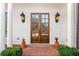 Double wooden doors with glass panels and lanterns at 2619 Green Meadows Ln, Brookhaven, GA 30319