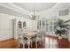 Bright dining room featuring a large table, chandelier, and hardwood floors at 335 Boundary Pl, Roswell, GA 30075