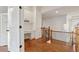 Second-story hallway with built-in desk, hardwood floors, and decorative wrought iron railing at 335 Boundary Pl, Roswell, GA 30075