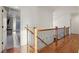 Elegant hallway with hardwood floors and wrought iron railing at 335 Boundary Pl, Roswell, GA 30075