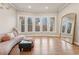 Bright living room featuring hardwood floors, large windows, and a large gold mirror at 335 Boundary Pl, Roswell, GA 30075