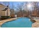 Backyard pool with rock waterfall feature, sunning deck, outdoor dining and lounging areas at 335 Boundary Pl, Roswell, GA 30075