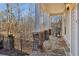 Cozy covered porch featuring stone floors, columns, and a relaxing rocking chair at 335 Boundary Pl, Roswell, GA 30075