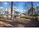 Spacious backyard with a wood fence, mature trees, and detached deck at 1379 Chatley Way, Woodstock, GA 30188