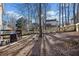 Large backyard featuring deck, mature trees, and new wood fence at 1379 Chatley Way, Woodstock, GA 30188