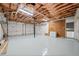 Spacious basement with garage door, insulated ceiling, pegboard wall, and epoxy floor at 1379 Chatley Way, Woodstock, GA 30188