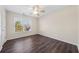 Well-lit bedroom with dark hardwood floors and ceiling fan at 1379 Chatley Way, Woodstock, GA 30188