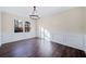 Bright dining room with dark hardwood floors and wainscoting at 1379 Chatley Way, Woodstock, GA 30188