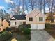 Charming two-story home featuring a well-maintained lawn and an attached two-car garage at 1379 Chatley Way, Woodstock, GA 30188