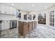 Modern kitchen with stainless steel appliances, white cabinets, and large island at 1379 Chatley Way, Woodstock, GA 30188