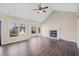 Living room with hardwood floors, fireplace, and vaulted ceiling at 1379 Chatley Way, Woodstock, GA 30188