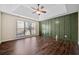 Main bedroom boasts a tray ceiling, ceiling fan, statement wall, and bright natural light at 1379 Chatley Way, Woodstock, GA 30188