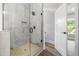 Walk-in shower featuring gray tile surround, tiled niche, and glass door at 321 Evie Ln, Canton, GA 30115