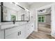 Bathroom featuring double sink vanity with stone countertop and an expansive mirror at 321 Evie Ln, Canton, GA 30115