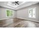 Large bedroom with tray ceiling, ceiling fan and views of the tree lined yard at 321 Evie Ln, Canton, GA 30115