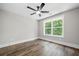 Bright bedroom with a large window and a modern ceiling fan at 321 Evie Ln, Canton, GA 30115
