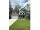 Charming two-story home featuring stone accents, a well-manicured lawn, and an attached two-car garage at 321 Evie Ln, Canton, GA 30115