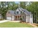Charming two-story home boasts stone accents, a welcoming porch, and an attached two car garage at 321 Evie Ln, Canton, GA 30115