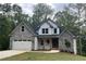 Attractive two-story home with a stone and siding exterior and a well-maintained lawn and charming front door at 321 Evie Ln, Canton, GA 30115