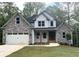 Beautiful two-story home featuring stone and siding, complemented by a manicured lawn and inviting entry at 321 Evie Ln, Canton, GA 30115