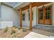 Inviting covered porch with stylish wood columns and a charming wood front door at 321 Evie Ln, Canton, GA 30115