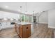 Modern kitchen with stainless steel appliances, island, and view of the living room fireplace at 321 Evie Ln, Canton, GA 30115
