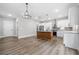 Modern kitchen features an island, stainless steel appliances, and ample cabinet space at 321 Evie Ln, Canton, GA 30115