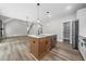 Open concept kitchen with stainless steel appliances and island with pendant lighting at 321 Evie Ln, Canton, GA 30115