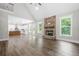 Spacious living room with high ceilings, hardwood floors, fireplace, and open access to the kitchen at 321 Evie Ln, Canton, GA 30115