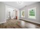 Bright living room featuring wood-look flooring, large windows and craftsman trim at 321 Evie Ln, Canton, GA 30115