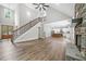 Expansive living area with fireplace, staircase, and open floor plan leading to the modern kitchen at 321 Evie Ln, Canton, GA 30115