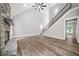 Bright living room featuring a stone fireplace, staircase, and hardwood floors with a neutral color palette at 321 Evie Ln, Canton, GA 30115