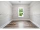 Spacious walk-in closet features wood-look flooring, shelving, and a window providing natural light at 321 Evie Ln, Canton, GA 30115
