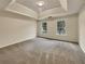 Spacious bedroom with neutral carpeting and two windows at 7391 Petal Pl, Fairburn, GA 30213